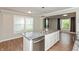 Kitchen island with granite counters and stainless steel dishwasher at 916 S Outer Dr, Lebanon, IN 46052
