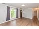 Bright living room with entry door and large windows with grey curtains at 916 S Outer Dr, Lebanon, IN 46052