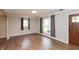 Living room with wood-look floors, neutral walls, and natural light from large windows at 916 S Outer Dr, Lebanon, IN 46052