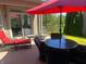 Backyard patio furnished with a red umbrella and dining furniture, perfect for outdoor enjoyment at 9789 Rue Renee Ln, McCordsville, IN 46055