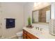 Bathroom with a marble countertop, wooden cabinets, and a large framed mirror at 9789 Rue Renee Ln, McCordsville, IN 46055