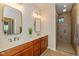 Bathroom featuring double sinks, quartz countertop, and a tiled walk-in shower at 9789 Rue Renee Ln, McCordsville, IN 46055