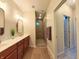 Bathroom features a large vanity with double sinks and tiled walk-in shower; a clean and luxurious space at 9789 Rue Renee Ln, McCordsville, IN 46055
