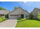 Charming single-story home boasts a well-manicured lawn and a welcoming front porch at 9789 Rue Renee Ln, McCordsville, IN 46055