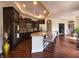 Open-concept kitchen with granite countertops, bar seating, dark cabinets and stainless steel appliances at 9789 Rue Renee Ln, McCordsville, IN 46055