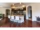 Spacious kitchen featuring an island with bar stool seating, dark wood cabinets, and modern appliances at 9789 Rue Renee Ln, McCordsville, IN 46055
