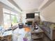Bright living room featuring fireplace, hardwood floors, neutral paint, and large windows at 9789 Rue Renee Ln, McCordsville, IN 46055