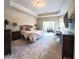 Bright main bedroom with a seating area, carpet, and a large window, creating a peaceful retreat for rest and relaxation at 9789 Rue Renee Ln, McCordsville, IN 46055