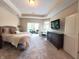 Spacious main bedroom features a tray ceiling, plush carpet, and an adjacent sitting area for relaxing at 9789 Rue Renee Ln, McCordsville, IN 46055