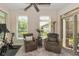 Bright sunroom with neutral walls, comfortable chairs, and an exercise bike at 9789 Rue Renee Ln, McCordsville, IN 46055