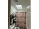 Cozy bathroom features skylight, sleek black shelving, and decorative patterned shower curtain at 1000 E Willard St, Muncie, IN 47302