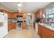 Cozy kitchen featuring wooden cabinets, updated appliances, and a seamless blend of functionality and style at 1000 E Willard St, Muncie, IN 47302