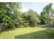 Expansive backyard with green grass, mature trees and a wooden fence at 10266 Hatherley Way, Fishers, IN 46037