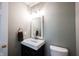 Chic half bathroom with modern fixtures, vanity, and convenient layout at 10266 Hatherley Way, Fishers, IN 46037