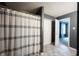 Bathroom featuring stylish gray walls, shower with white curtain, and closet for storage at 10266 Hatherley Way, Fishers, IN 46037