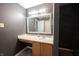 A bathroom vanity with neutral countertop, framed mirror and storage underneath at 10266 Hatherley Way, Fishers, IN 46037