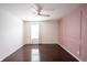 Bedroom with wood flooring and a modern light fixture at 10266 Hatherley Way, Fishers, IN 46037