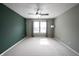 Bright bedroom with a ceiling fan, large windows, and neutral carpet at 10266 Hatherley Way, Fishers, IN 46037