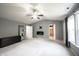Bedroom with carpet, vaulted ceilings, ceiling fan, and bright windows with dark curtains at 10266 Hatherley Way, Fishers, IN 46037