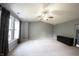 Bedroom with vaulted ceilings, ceiling fan, carpet, and a bright window with curtains at 10266 Hatherley Way, Fishers, IN 46037
