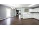 Dining room with an updated chandelier, new flooring and open to the kitchen and living room at 10266 Hatherley Way, Fishers, IN 46037