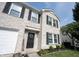 Charming two-story home featuring a brick facade, black door and manicured lawn at 10266 Hatherley Way, Fishers, IN 46037