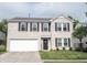 Charming two-story home featuring a brick facade, attached garage and manicured lawn at 10266 Hatherley Way, Fishers, IN 46037