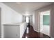 Bright hallway with hardwood floors and an open doorway to a carpeted room at 10266 Hatherley Way, Fishers, IN 46037