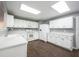 Well-lit kitchen with white cabinets, stainless appliances, and a skylight at 10266 Hatherley Way, Fishers, IN 46037