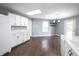 View of the kitchen and eat-in area with white cabinetry and floors at 10266 Hatherley Way, Fishers, IN 46037