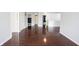 Living room featuring dark hardwood floors with white trim, and open doorways to other rooms at 10266 Hatherley Way, Fishers, IN 46037