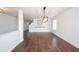 Bright living room with hardwood floors, modern lighting, and a staircase at 10266 Hatherley Way, Fishers, IN 46037