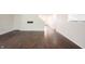 Open-concept living room with laminate floors, neutral walls, and an adjacent staircase to the 2nd floor at 10266 Hatherley Way, Fishers, IN 46037