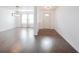 Open-concept living room featuring hardwood floors, modern lighting, and lots of natural light at 10266 Hatherley Way, Fishers, IN 46037