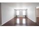 Bright living room featuring hardwood floors, with grey walls, windows with curtains and white trim at 10266 Hatherley Way, Fishers, IN 46037