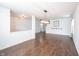 Spacious living room with hardwood floors, modern lighting, and a staircase at 10266 Hatherley Way, Fishers, IN 46037