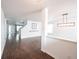 Spacious living room featuring hardwood floors, modern lighting, and a staircase at 10266 Hatherley Way, Fishers, IN 46037
