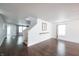 Open-concept living room featuring hardwood floors, modern lighting, and a staircase at 10266 Hatherley Way, Fishers, IN 46037