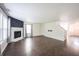 Living room featuring a fireplace, wood-look floors, and an adjacent staircase to the 2nd floor at 10266 Hatherley Way, Fishers, IN 46037