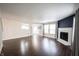 Large living room with windows, hardwood floors, neutral paint and view to the dining room at 10266 Hatherley Way, Fishers, IN 46037