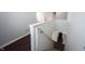Staircase with white walls, carpet stairs, and dark hardwood floors on the landing at 10266 Hatherley Way, Fishers, IN 46037