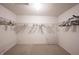 Spacious walk-in closet with ample wire shelving, shoe racks, and neutral carpet at 10266 Hatherley Way, Fishers, IN 46037