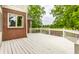 Spacious back deck with white railings overlooking the landscaped backyard and green space at 10554 Hyde Park, Carmel, IN 46032