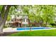 Lush backyard with in-ground pool, mature trees, and well-maintained landscaping, creating a private oasis at 10554 Hyde Park, Carmel, IN 46032