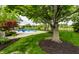 Spacious backyard with in-ground pool, mature trees, and lush green lawn, perfect for outdoor enjoyment at 10554 Hyde Park, Carmel, IN 46032