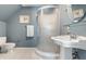 Compact bathroom with a pedestal sink, shower, and toilet, designed for functionality and ease of use at 10554 Hyde Park, Carmel, IN 46032