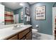 Bathroom with a modern sink vanity, framed art, and a combination shower and tub, blending style and functionality at 10554 Hyde Park, Carmel, IN 46032