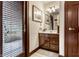 Bathroom with a vanity, white countertops, a mirror, and wooden door and window trim at 10554 Hyde Park, Carmel, IN 46032