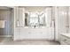 Bright primary bathroom with a double vanity and large mirrors, providing ample space and natural light at 10554 Hyde Park, Carmel, IN 46032