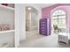 Charming bedroom boasts a window seat and built-in shelves near the ensuite bath at 10554 Hyde Park, Carmel, IN 46032